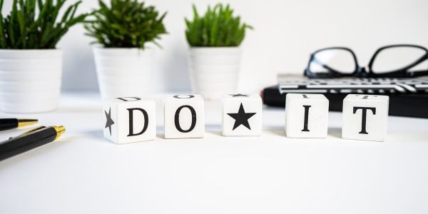 Inspiring office scene with 'Do It' blocks and plants, perfect for motivation.
